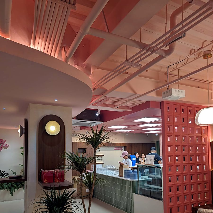 Café counter beside a red breeze-block screen