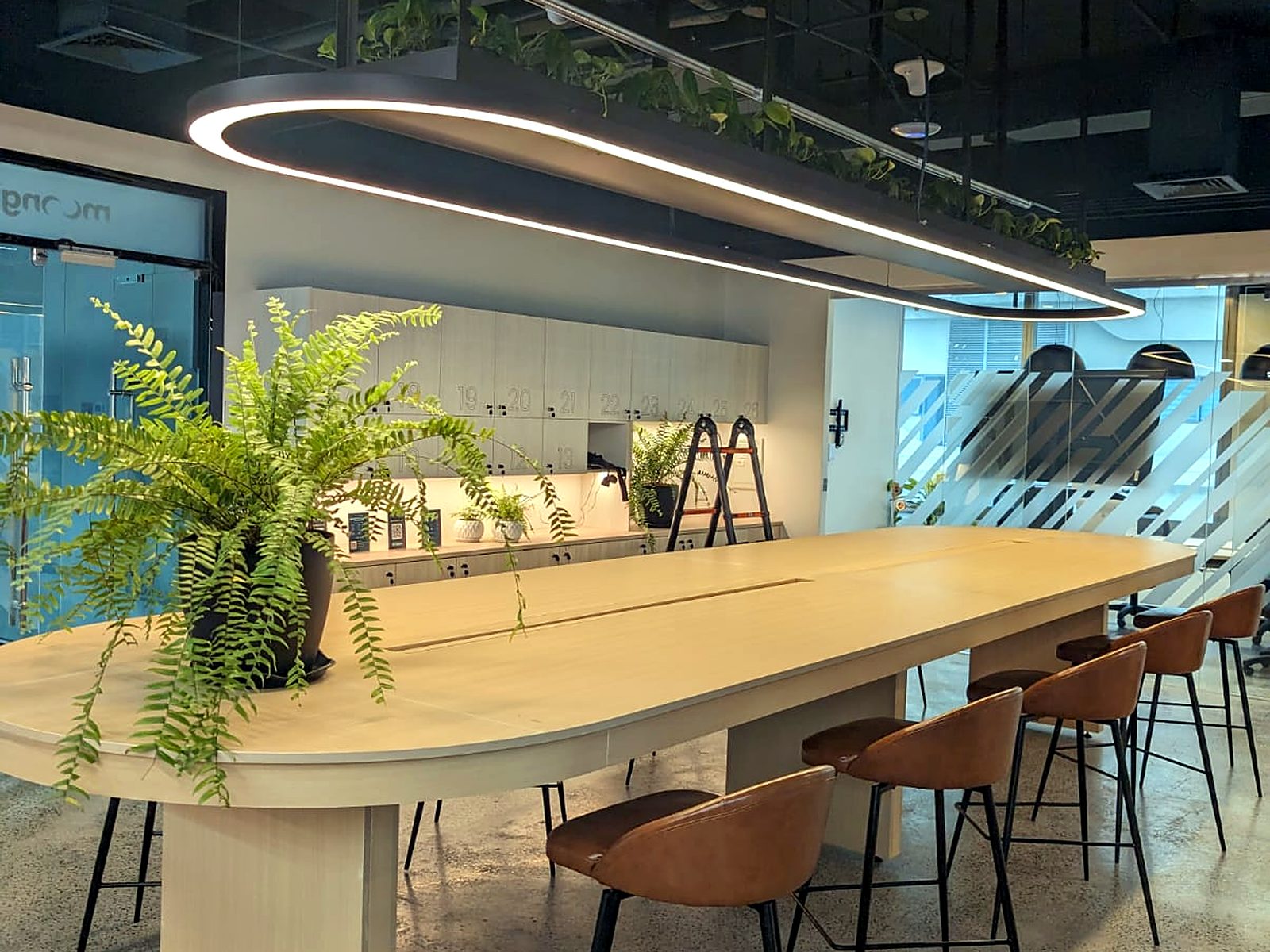 Communal table under an oval pendant light