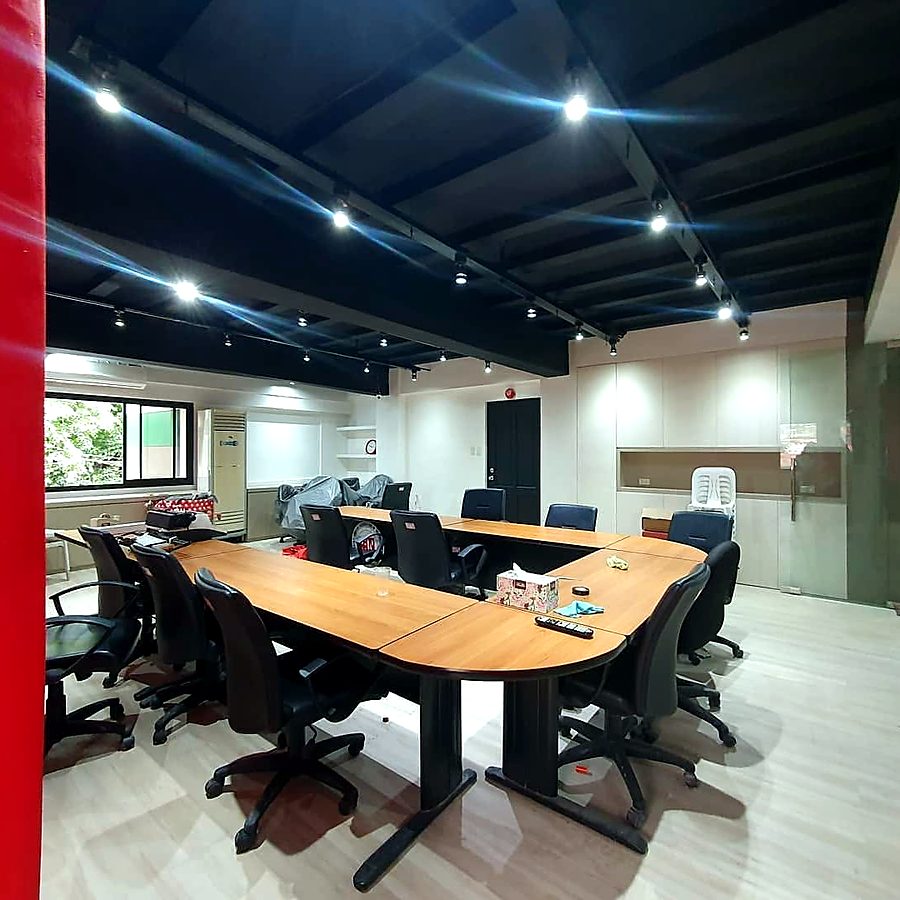 U-shaped meeting table under track lights